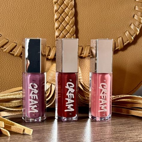 Which Fenty Gloss Bomb Cream are you wearing today😇🤔 Shades [ Mauve Glitz, Fruit Snackz & Fenty Glow]. Each at 125k🇺🇬. Call/Whatsapp 0704 261 720 for deliveries. . #fentybeauty #glossbombcream #beautytrendsuganda #glossbombcream #tuesday #lipglosslover #fenty #beauty #onlinestore #trending #grwmmakeup #lipglosslover #beautymaven #eastafrica #kampalauganda Fenty Gloss, Creamy Color, Black Art Pictures, Lip Cream, Fenty Beauty, Call Whatsapp, Beauty Trends, Lip Gloss, Lips