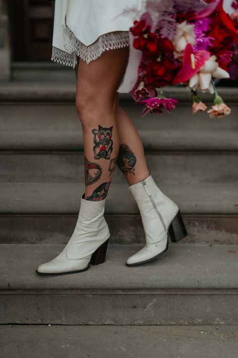 Bride wearing short alternative wedding dress and white patent heeled ankle boots with black soles | Mark Horton Photos