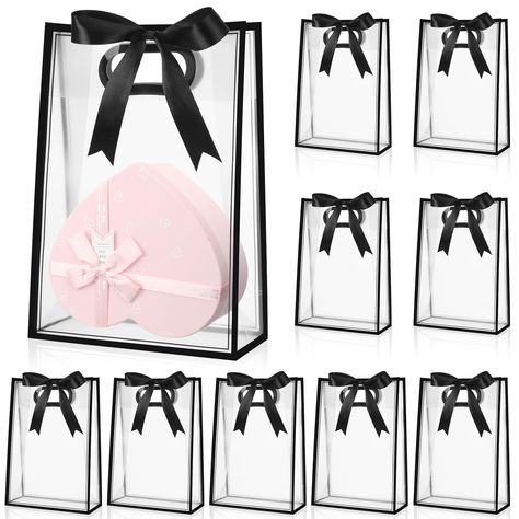 PRICES MAY VARY. Roomy Size and Quantity: with a clear gift bag size of about 7 x 10 x 3.15 inches/ 18 x 26 x 8 cm and a roll of 72 ft ribbon, the clear gift bags with ribbons provide ample space for your presents and nice decoration to wrap; The clear plastic gift bags package includes a set of 12 bags, which caters efficiently to your needs for large events or parties; The generous quantity and roomy size make it your ideal gift packaging solution Clear Design with an Elegant Border: the clear Clear Gift Bags, Plastic Gift Bags, Birthday Goodie Bags, Party Favors For Adults, Retail Bags, Party Goodies, Transparent Bag, Packaging Supplies, Favor Bag