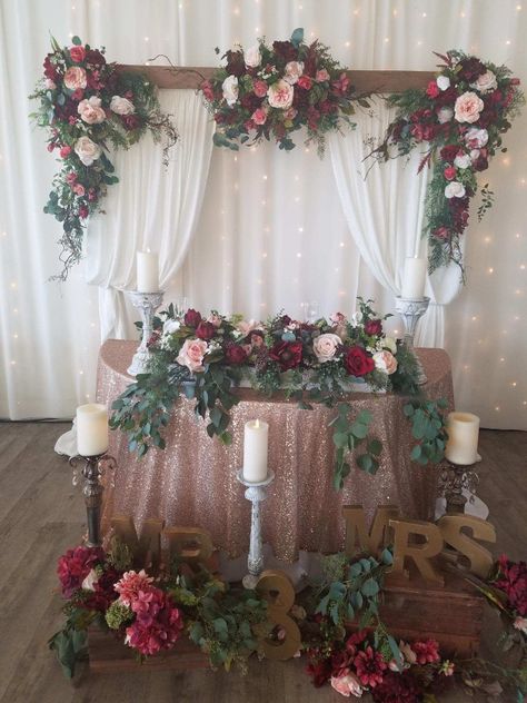 Arch with drapery and 3 flower swags, and 1 sweetheart table centerpiece with lots of eucalyptus Burgundy And Pink Wedding Decorations, Dusty Rose Sweetheart Table, Bride And Groom Table Burgundy, Burgundy Wedding Sweetheart Table, Burgundy And Blush Wedding Sweetheart Table, Burgundy Sweetheart Table Flowers, Blush Sweetheart Table, Ivory Wedding Decor, Burgundy Blush Wedding