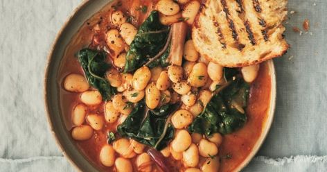 Vegan Shortcut Brothy Beans | VegNews Brothy Beans, Beans And Greens, Parmesan Rind, Canned Butter, Food Issues, Butter Beans, Recipe Steps, Dried Beans, Bean Recipes