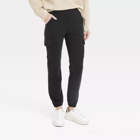 Tailored in a slim-fit silhouette, these mid-rise cargo jogger pants are crafted from a soft, midweight fabric with spandex for all-day stretchy comfort. Featuring a wide waistband that stays comfortable on your waist, these relaxed-fit joggers feature two side stash pockets and two side cargo pockets that you can use to hold small essentials. #travelpants #travelattire #affordabletravelpants #joggers #traveljoggers #travelwants #travelneeds #target Jogger Cargo Pants, Cargo Jogger Pants, Black Jogger Pants, Sweat Joggers, Travel Pants, Fitted Joggers, Cargo Joggers, Black Joggers, Hem Style