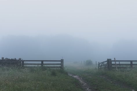 A wet track going through a gate in the countryside. On a rainy, foggy day. Bredon Hill, Cotswolds, UK Foggy Day, Gate, Track, Wall