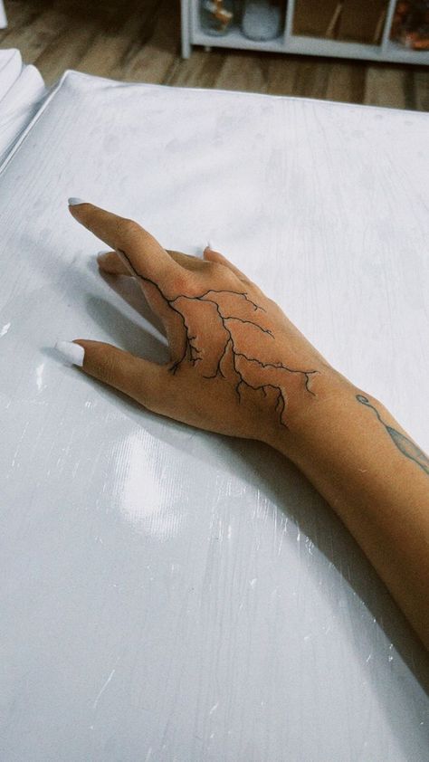 250+ Lightning Tattoos Ideas and Designs (2023) - TattoosBoyGirl Hand Lighting Tattoo, Hand Tattoos For Guys Lightning, Lightning On Hand Tattoo, Lightning Tattoo Men Hand, Hand Tattoos For Women Lightning, Lightening Hand Tattoos, Arm Tattoo Lightning, Lighting Tattoo Arm Sleeve, Hand Tattoos Lightning Bolt