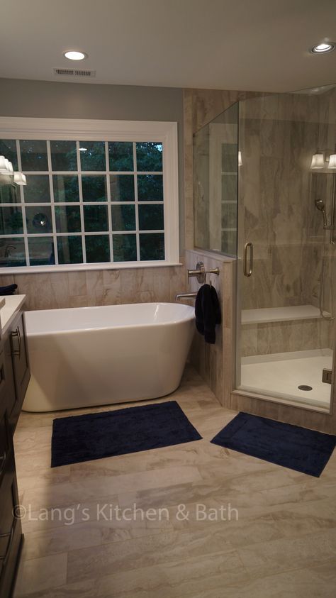 This transitional style bathroom design offers a soothing retreat with elegant design details.  The angled shower features a custom storage niche and corner storage shelf, and the freestanding tub offers a quiet place to relax.  Two hanging vanities are accented by toe kick lights and porcelain plank floor tile, and finished off with sophisticated mirrors that complement the faucets. Transitional Style Bathroom, Japanese Soaking Tubs, Bad Inspiration, Master Bath Remodel, Corner Storage, Style Bathroom, Freestanding Tub, Bathroom Remodel Shower, Custom Storage