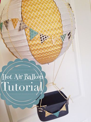 These cute hot air balloons are made using a paper lantern, scrap book paper, chip wood boxes and string Hot Air Balloon Decoration, Air Balloon Decoration, Theme Bapteme, Diy Hot Air Balloons, Hot Air Balloon Party, Hot Air Balloon Decorations, Dekor Diy, Ornament Tutorial, Baby Shower Balloons