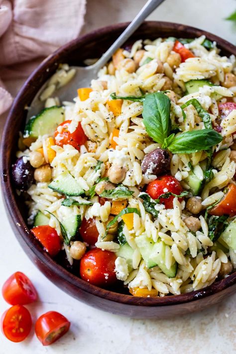 This Greek-inspired orzo pasta salad recipe is loaded with Mediterranean flavor thanks to the feta, olives, chickpeas, and basil. Delish! Orzo Pasta Salad With Chickpeas, Basil Side Dishes, Orzo Salad Dressing, Orzo Salad Recipes Cold, Orzo Dinner, Savory Potato Salad, Orzo Pasta Salad Recipe, Orzo Salat, Greek Orzo