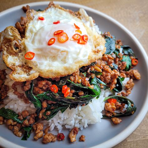 Pad Ka Prao is a spicy, savory, one-dish meal of stir-fried chicken and basil served over rice with a crispy egg. Thai Minced Pork, Pad Kra Pao, Thai Beef, Thai Street Food, Spicy Beef, Thai Basil, Thai Dishes, Holy Basil, Asian Flavors