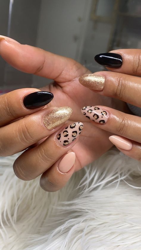 Nude almond nails with gold glitter and black matte with  cheetah print nail art. Chitah Print Nails, Almond Nails Designs Cheetah, Leopard Print Nails Almond Shape, Lepord Print Nail Design, Chetta Print Nail, Leapord Print Nail Art, Fall Cheetah Print Nails, Almond Nails Leopard, Nude Nail Designs Almond Shape