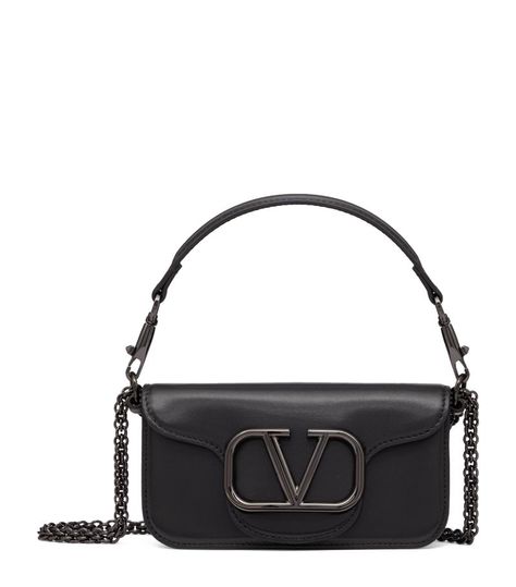 Find VALENTINO Leather Loco Shoulder Bag on Editorialist. With a House as illustrious as Valentino Garavani, one simply has to glance at the logo to recognise its serious style credentials, so the Loco shoulder bag keeps it front and centre. The VLogo is the only adornment on this soft calf leather design, allowing its simple lines and high-shine hardware to do the heavy lifting. Valentino Garavani Bag, Girly Accessories, Trainer Boots, Luggage Accessories, Small Shoulder Bag, Stylish Bag, Black Cross Body Bag, Body Style, Leather Design