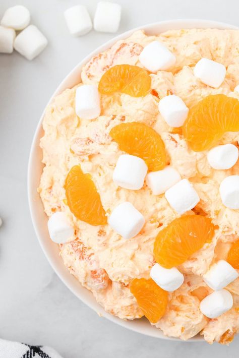 orange creamsicle salad in a bowl Orange Dream Cicle Salad, Creamsicle Salad Recipe, Orange Cool Whip Dessert, Pretzel Presents, Orange Creamsicle Fluff, Fluff Deserts, Snicker Salad Recipe, Fluffy Jello, Orange Creamsicle Salad