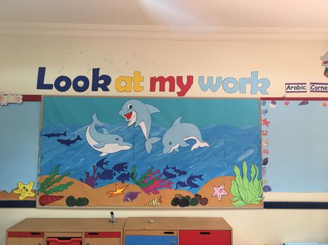 My work  Bulletin board  Under the sea theme (dolphins) Dolphin Bulletin Board Ideas, Bulletin Board Under The Sea, Work Bulletin Board, Dolphin Craft, Dolphin Decor, Finger Gym, Under The Sea Decorations, Ocean Theme Classroom, Preschool Classroom Decor