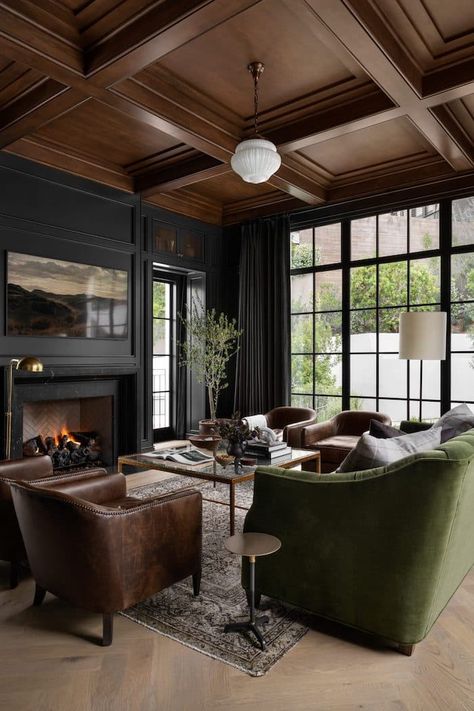 5 Ways To Create A Whole Home Paint Color Scheme. Modern living room with black walls and wood ceiling. Moody Media Room, Dark Moody Living Room, Hilltop Estate, Moody Interior Design, Mission Style Homes, Moody Living Room, Light Colored Furniture, Home Paint Color, Moody Decor