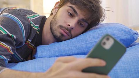 Young man playing on the phone falls asleep in bed. Young man looking at phone in his room and sleeping. Phone addicted young man. Looking At Phone, On The Phone, Sleeping In Bed, Wedding People, Football Pictures, Ap Art, Free Stock Video, Cityscape Photos, Logo Banners