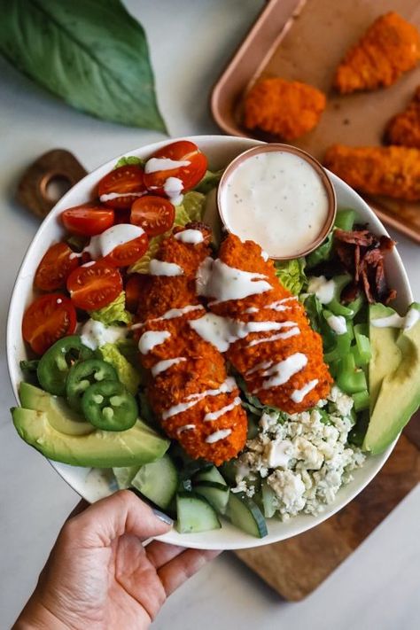 Baked buffalo cashew coated chicken fingers on a bed of romaine with tomatoes, avocado, turkey bacon, jalapeño, cucumber, gorgonzola, & ranch dressing! Chicken Finger Salad, Buffalo Chicken Salads, Cashew Crusted Chicken, Buffalo Chicken Fingers, Entree Salads, Family Dinner Menu, Chicken Finger, Chicken Salads, Creamy Ranch Dressing