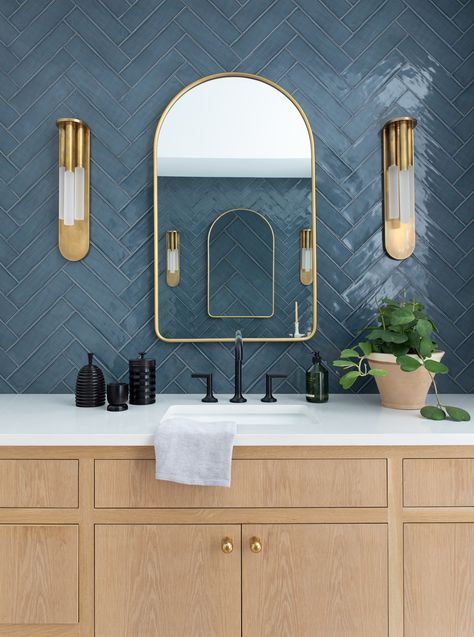 Stunning chevron tile and black and brass accents with white oak cabinets. Blue Herringbone Tile, Dark Blue Tile, Blue Tile Wall, Bathroom Ambiance, Bath Makeover, Oak Bathroom, Contemporary Bathroom Designs, Modern Lighting Design, Morning Routines