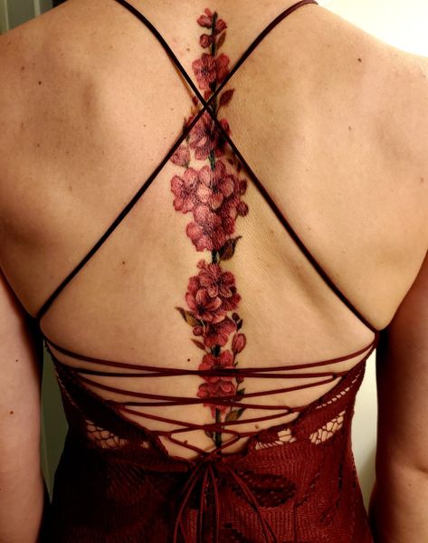 Feminine Back Tattoos Cover Up, Spine Tattoo Red, Spine Tattoo Cover Up Ideas, Red Back Tattoos Spine, Red Spine Tattoo, Red Spine Tattoos For Women, Cherry Blossom Spine Tattoo, Red Ink Spine Tattoo, Tattoo Cherry Blossom