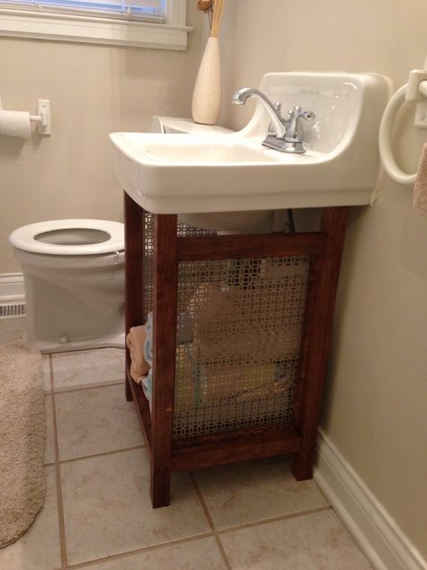 Solution for old wall mounted sink that is super hard to replace: pine boards and vent grate make a cute, open vanity with plenty of storage and hides the ugly old pipes. Under Bathroom Sinks, Under Bathroom Sink, Bathroom Sink Storage, Sink Cover, Wall Mounted Sink, Shabby Chic Bathroom, Sink Storage, Pedestal Sink, Toilet Design