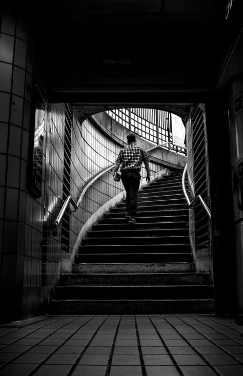 A man walks up the stairs of a subway in London. Stairs Photography, Walking Up Stairs, Up Stairs, Stairs, Walking, Black And White, Photography, White, Black