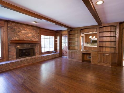 BEFORE: Old school wood paneling and bricks made this living room seem small and cramped. The lowered ceiling and a huge built-in bookcase weren't helping either by wasting valuable space. Wood Built Ins, Dark Wood Paneling, Christina Anstead, Hgtv Property Brothers, Drew And Jonathan Scott, Hgtv Kitchens, Decorate Room, Yellow Cabinets, Living Room Built Ins