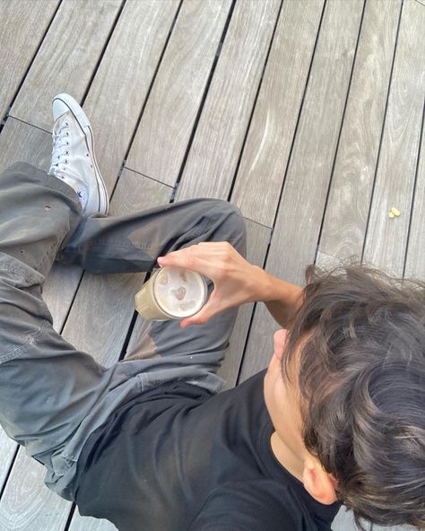 a boy is sitting on a wood floor, and is holding an inced latte.
He is wearing a y2k outfit and has brown hair.
The photo is taken from the top Boy Aesthetic Faceless, Six Aesthetic, The Atlas Six, Bad Boy Aesthetic, Masculine Style, Boy Aesthetic, Dance Academy, All I Ever Wanted, Anime Dancer