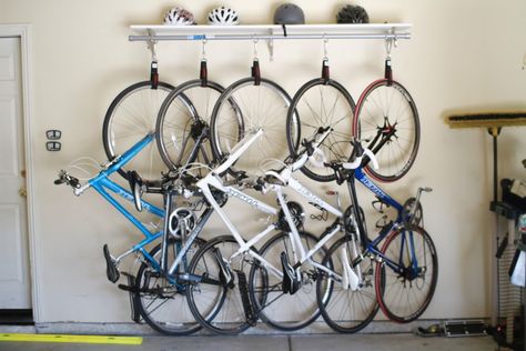 DIY Bike Rack for 90 bucks | heavy duty velcro straps, hooks/carabiners, pole, and shelf above for helmets/pads, etc. Hanging Bike Rack, Diy Bike Rack, Garage Ceiling Storage, Bike Rack Garage, Simple Bike, Bike Storage Garage, Bike Storage Solutions, Garage Ceiling, Bike Storage Rack