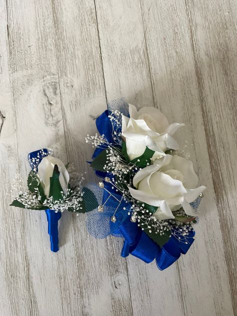 Blue And Silver Boutonniere, Royal Blue And White Boutonniere, Blue And White Corsage And Boutonniere, Wrist Corsage For Royal Blue Dress, Royal Blue Prom Flowers Wrist Corsage, Prom Wrist Corsage Ideas Royal Blue, Corsage And Boutonniere Set Blue, Dark Blue Corsage And Boutonniere, Royal Blue Corsage And Boutonniere Prom