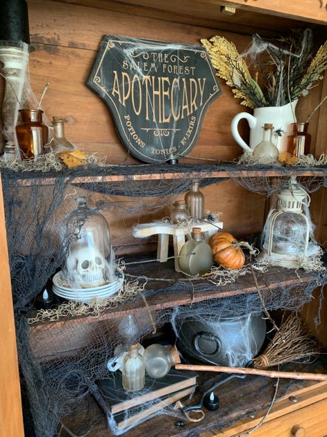 Halloween Decorations Apothecary, Halloween Witch Apothecary, Spooky Apothecary Display, Halloween Decor Apothecary, Apothecary Cabinet Halloween, Halloween Kitchen Cabinets, Halloween Hutch Display, Halloween Curio Cabinet, Witches Apothecary Cabinet