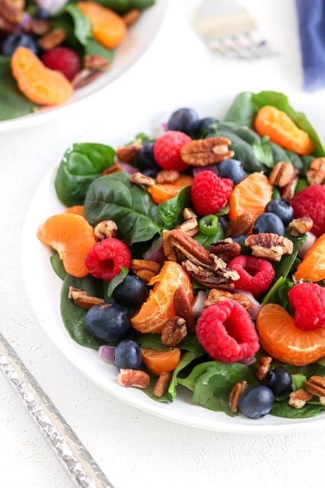 This succulent, crunchy Berry Spinach Salad is made with fresh spinach leaves, blueberries, raspberries, mandarin oranges, onions, cilantro, and pecans. Toss together and enjoy as is or drizzle Raspberry Vinaigrette Dressing over the top! #paleosalads #paleorecipes #saladrecipes #glutenfreerecipes | spiritedandthensome.com Raspberry Spinach Salad, Spinach And Berry Salad, Spinach And Orange Salad, Raspberry Salad Recipes, Mango Spinach Blueberry Salad, Spinach Salad With Strawberries And Blueberries, Berry Spinach Salad With Blueberries And Raspberries, Raspberry Vinaigrette Dressing, Raspberry Salad