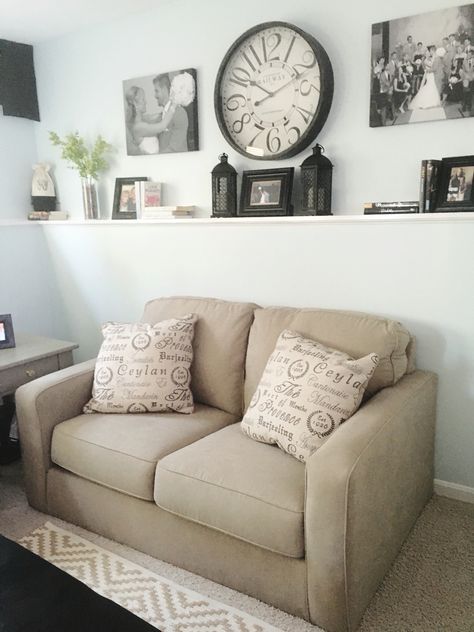 Light Khaki love seat, big clock and gallery wall Picture Frames Behind Couch, Living Room Wall Decor With Clock, Decor Ideas Above Couch, Ideas Above Couch, Wall Decor Behind Couch, Couch Wall Decor, Family Room Wall Decor, Room Clock, Big Clock