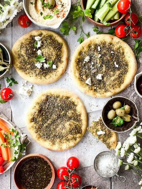 Za'atar Bread (Manakeesh) is a much-loved Mediterranean flatbread enjoyed by many. You've probably tasted it at Lebanese eateries or Mediterranean bakeries. This za'atar bread is truly delicious! But if you haven't had the pleasure yet, don't worry. Today, I'm excited to share with you an effortless homemade Za'atar bread recipe that will have you craving more with every bite. Zaatar Bread Recipe, Zaatar Bread, Mediterranean Flatbread, Easy Breakfast Brunch, Middle Eastern Dishes, Za Atar, Pizza Stone, Middle Eastern Recipes, Vegetarian Cheese