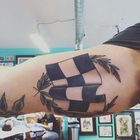 Recent traditional racing flag tattoo from Andy Canino @ Dedication Tattoo Racing Flag Tattoo, Racing Tattoos For Women, Race Car Tattoo, Checkered Flag Tattoo, Dedication Tattoos, Stripe Tattoo, Cover Up Tattoos For Men, Wreath Tattoo, Racing Tattoos