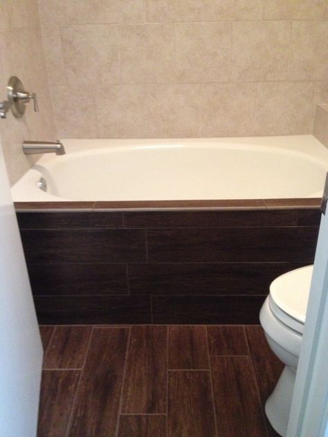 Dark walnut wood tile floor and bathtub face. Contrast with Rialto white tile bathtub surround. Tile Bathroom Design, Remodeling Furniture, Ceramic Wood Tile Floor, Ash Wood Floor, Wood Tile Floor, Bathroom Facelift, Tile Bathtub, Wood Tile Shower, Walnut Bathroom