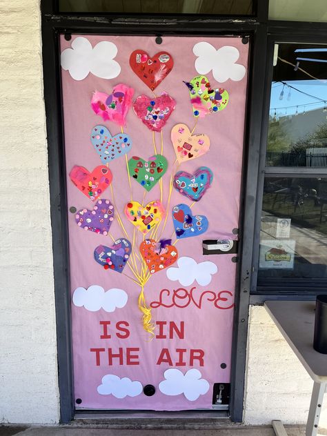 Daycare February Themes, Love Is In The Air Door Decoration, Valentine Preschool Bulletin Board Ideas, Classroom Doors For Valentines Day, Friendship Classroom Door, Valentine’s Classroom Door, Classroom Door Ideas Valentines Day, Valentine’s Day Door Theme, Love Is In The Air Bulletin Board