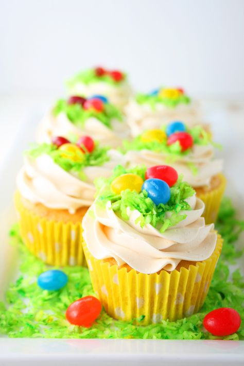 Easter Egg Cupcakes - delicious lemon cupcakes with homemade Swiss meringue buttercream frosting, green coconut grass and jelly beans. Get the recipe on MomLovesBaking.com. #ad Easter Basket Cupcakes, Easter Cupcakes Easy, Egg Cupcakes, Easter Sweets, Oreo Cupcakes, Easter Cupcakes, Baking Blog, Easter Dessert, Easter Cakes