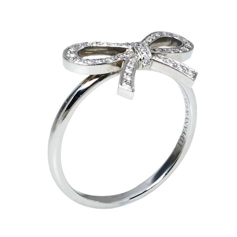 Buy 100% authentic Tiffany & Co. Tiffany Bow Diamond Platinum Ring Size 53 Tiffany & Co. and enjoy offers up to 80% off. We offer quick delivery whether you’re in UAE, KSA, Kuwait and worldwide! Bow Engagement Ring, Tiffany Engagement Ring, Buy Rolex, Buy Louis Vuitton, Platinum Diamond Rings, Bow Ring, Chanel Belt, Louis Vuitton Belt, Buy Gucci