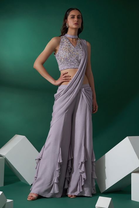 Lilac pre-draped pant saree. Paired with hand embroidered blouse with floral motifs. Component: 2 Pattern: Embroidered Type Of Work: Floral  Neckline: V neck Sleeve Type: Sleeveless Fabric: Georgette crepe and satin Color: Purple Other Details:  Ruffle saree Sleeve has daunting craftmenship Closure: Back hook open Occasion: Reception - Aza Fashions Modern Saree With Pants, Drape Saree With Pants, Drape Saree Indo Western, Saree With Pants, Engagement Party Attire, Pant Saree, Hand Embroidered Blouse, Fancy Shirt, Drape Pants