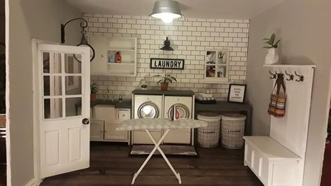 Wire laundry baskets are napkin rings found at Hobby Lobby. Ironing board made from jumbo popsicle stick and skewer sticks. Folding table and washer/dryer counter made from scrap wood. Sink was purchased, but was modified by painting and adding a more modern faucet. Hall tree/mud room bench made from a purchased chest and scrap wood. Lighting fixture is a purchased metal tin from Hobby Lobby minis section with a magnetic mini light also from  there. Washer/dryer purchased and modified. House Laundry Room, Skewer Sticks, Room Box Miniatures, Modern Dolls House, Dollhouse Design, Modern Dollhouse Furniture, Wood Sink, Farmhouse Laundry, Dollhouse Miniature Tutorials