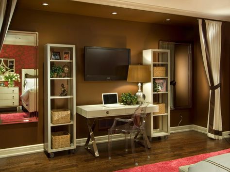 A white lacquer desk and iconic ghost chair create a stylish spot for a teenager to study. Curtains frame the space, visually separating it from the adjoining bedroom. Design: Anne Rue Tv Over Desk, Office Tv Room Combo, Desk In Bedroom, White Lacquer Desk, Lacquer Desk, Writing Room, Study Spaces, Hgtv Star, Micro Apartment