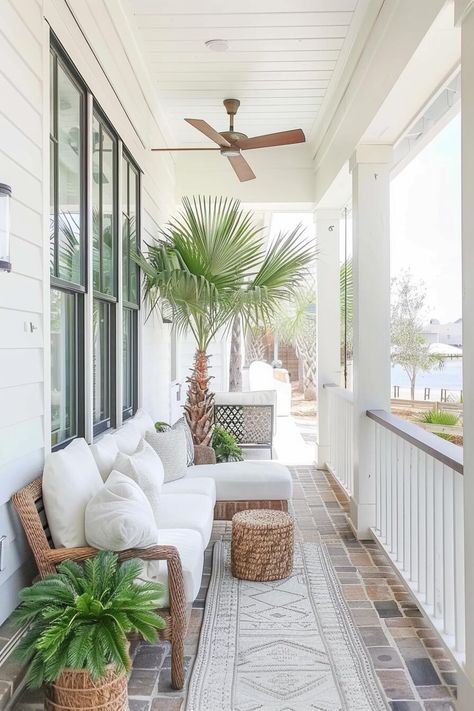 coastal front porch with potted palm tree and woven sofa with white cushions Outdoor Patio Mood Board, Coastal Front Garden, Beach Cottage Porch, Southern Porch Decorating Ideas, Coastal Porch Ideas, Tropical Front Porch, Beach Front Porch, Coastal Front Porch Ideas, Coastal Front Porch