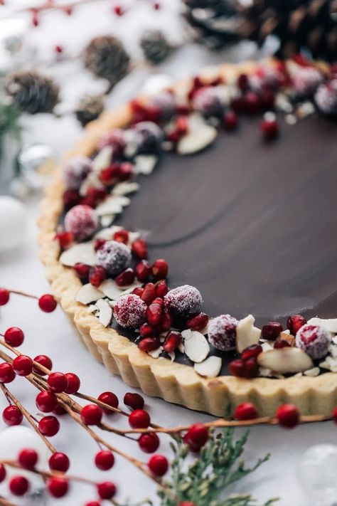 This Holiday Dark Chocolate Ganache Tart is the ultimate show-stopping holiday dessert. Each bite is perfectly balanced between sweet ganache, sugared cranberries, pomegranate seeds, and buttery shortbread tart dough. Christmas Dessert Tart, Christmas Chocolate Tart, Christmas Chocolate Pie, Christmas Dessert Fancy, Christmas Fruit Tart, Winter Fruit Tart, Christmas Dessert Chocolate, Christmas Tarts Desserts, New Years Baking Ideas