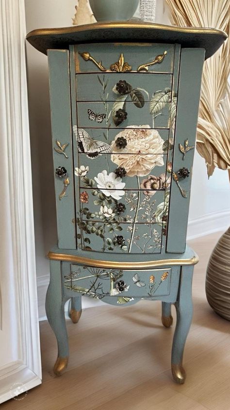 THIS SPECIFIC ITEM HAS SOLD, BUT I HAVE SEVERAL OTHERS IN PROGRESS. CONTACT ME IF INTERESTED, AND WE CAN CUSTOM DESIGN ONE JUST FOR YOU.  Absolutely stunning refinished jewelry armoire - I am literally obsessed with this piece After painting this in a lovely french blue called Duck Egg, not a detail was spared on decorating this piece. It has a fabulous, neutral floral design on the front, top and sides. All of the drawers, which are lined in green velvet, were decoupaged on both sides, which ma Jewelry Armoire Makeover, Painted Jewelry Armoire, Armoire Makeover, Painted Jewelry Boxes, Dressers Makeover, Flower Embellishments, Furniture Rehab, Painting Furniture Diy, Funky Painted Furniture