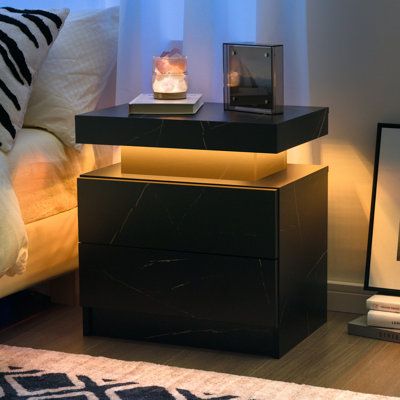 Specification: Product name: LED Beside the table. Material: MDF, LED light. Color: White. Weight Capacity: 66lb. Product Size: 19.3*13.7*20.5 in. Package Included: 1Pcs*LED beside table, 1pcs*instruction. Color: Black Marble | Ivy Bronx Bedside Table w / 2 Drawers, Led Nightstand Wooden Cabinet Unit w / Led Lights For Bedroom | 20.5 H x 19.3 W x 13.7 D in | Wayfair Modern End Tables For Bedroom, Bed Stands Bedside Tables, His And Hers Nightstands, Bed Side Table Black, Men Apartment Decor Bedroom, Small Black Nightstand, Black Bedside Table Ideas, Mens Home Decor Masculine Interior, Black Marble Bedroom