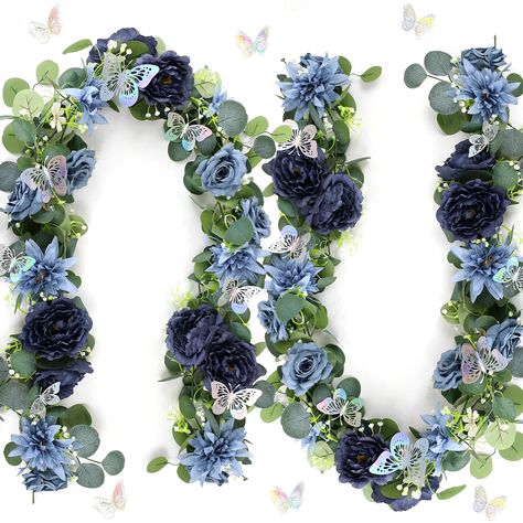 PRICES MAY VARY. Plastic & Faux Silk You will get 2 pack 12 FT artificial eucalyptus with navy blue fake rose, dahlia, and peony flowers, and pack of 24 silver butterflies. Each flower garland is 1.8 m/ 5.9 ft long. These eucalyptus garland with flowers are made of high quality silk and plastic. Comes with 3d silver butterflies, will make your flower vines a realistic, natural and thick fullness looking. These navy blue floral garland with eucalyptus will be perfect to decorate a white curtain b Blue Silver Centerpieces, Navy Blue Table Decor, Blue And Silver Wedding Decorations, Midnight Blue Wedding Theme, Wedding Table Backdrop, Fake Flower Garland, Garlands For Wedding, Garland With Flowers, Simple Table Centerpieces