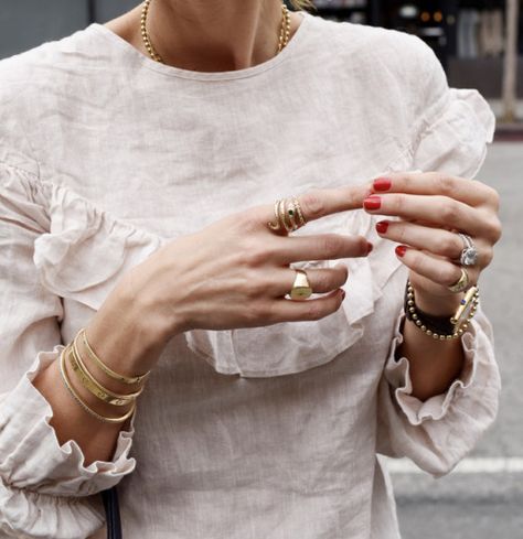 layering jewelry, minimalist jewelry, ruffle top, red nails, classic watch, signet ring Mode Tips, Farrah Fawcett, Layered Jewelry, Classic Watches, Looks Chic, Ruffle Top, Signet Ring, Minimalist Jewelry, Red Nails