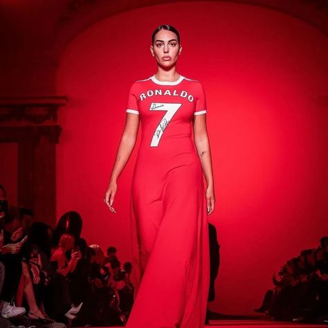 Cristiano Ronaldo’s wife, Georgina Rodriguez, made a significant appearance at Paris Fashion Week, walking for Vetements in a red dress that merged football jersey elements with an elegant pleated train skirt, reflecting her bond with the football legend. This event marked Vetements’ decade in the industry, attracting widespread attention and featuring a range of oversized and distinctively styled pieces​​. Photos: @vetements_official #gclasslife #carswithclass #luxlife #luxurylifestyle #B... Train Skirt, Georgina Rodriguez, Football Jersey, Cristiano Ronaldo, Luxury Lifestyle, Ronaldo, Paris Fashion, Paris Fashion Week, Red Dress