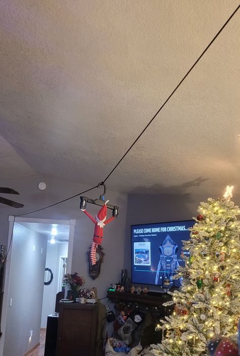 Lightweight cord, clothes hanger and some thumb tacks ;) Elf Zip Line Ideas, Elf On The Shelf Ideas Zipline, Zip Lining Elf On The Shelf, Zipline Elf On The Shelf, Elf On The Shelf Zip Line Ideas, Zip Line Elf On Shelf, Elf Zipline Ideas, Elf On The Shelf Zip-line Idea, Elf Zipline