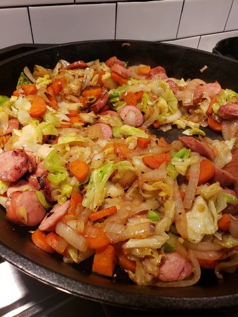 Kielbasa cabbage and onions This is a one skillet dinner!  1 package kielbasa  1/2 head cabbage,  chopped 1 large onion 2 carrots,  sliced 2 garlic cloves In a large skillet over medium,  brown the... Cabbage Onions And Sausage, Kielbasa And Cabbage Skillet, Cabbage Skillet Recipes, Keilbasa And Cabbage, Fried Cabbage And Kielbasa, Cabbage And Kielbasa, Recipes Carrots, Kilbasa Sausage Recipes, Kielbasa Cabbage