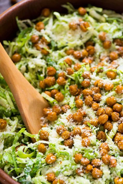 This Caesar Brussel Sprouts Salad tastes INCREDIBLE. Creamy Caesar dressing, crispy roasted chickpea “croutons” and raw shaved brussels sprouts. Lasts for days in the fridge, so it’s perfect for a make ahead holiday side dish and healthy lunches too! Brussel Sprouts Salad, Chickpea Croutons, Crispy Roasted Chickpeas, Shaved Brussel Sprout Salad, Crispy Chickpea, Brussel Sprout Salad Recipes, Fried Brussel Sprouts, Shaved Brussel Sprouts, Roasted Chickpea