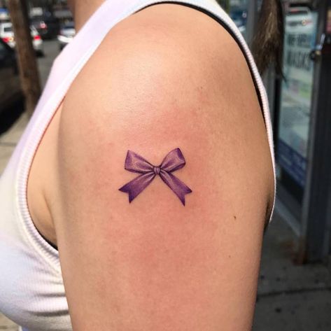 Micro-realistic purple ribbon tattooed on the shoulder. Purple Ribbon Tattoos, Bow Tattoo, Ribbon Tattoos, Cute Tats, Purple Bows, Purple Ribbon, Tattoos For Kids, Little Tattoos, Cheer Bows